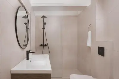 a white bathroom with a sink and a mirror at Athenian Riviera Panorama Villa in Athens
