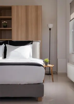 a bedroom with a large bed and a table at Athenian Riviera Panorama Villa in Athens