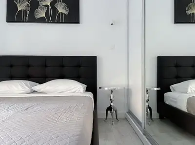 a bedroom with a black and white bed and a mirror at Lucky Premium Home #11 VIPGreece in Athens