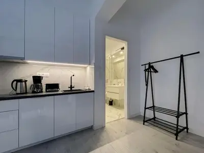a kitchen with white cabinets and a tripod in a room at Lucky Premium Home #11 VIPGreece in Athens