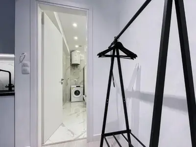 a black tripod in a room with a door at Lucky Premium Home #11 VIPGreece in Athens