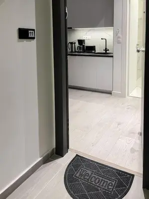 a door to a kitchen with a rug on the floor at Lucky Premium Home #11 VIPGreece in Athens