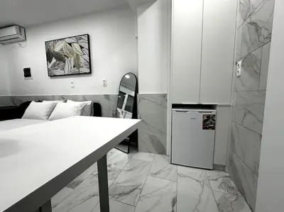 a room with a kitchen with a table and a refrigerator at Beautiful Apartment For Two VIPGreece in Athens