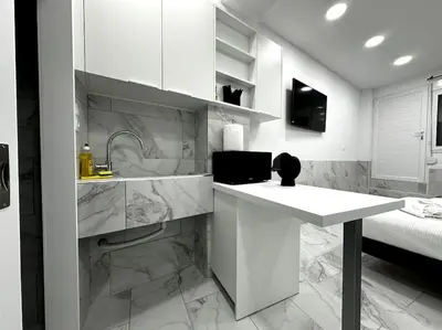 a white kitchen with a counter and a sink at Beautiful Apartment For Two VIPGreece in Athens