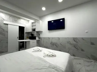 a bedroom with a bed and a tv on the wall at Beautiful Apartment For Two VIPGreece in Athens