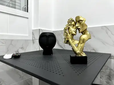 a black table with a gold statue on it at Beautiful Apartment For Two VIPGreece in Athens