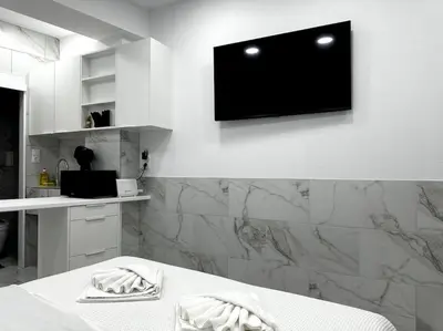 a room with a flat screen tv on a wall at Beautiful Apartment For Two VIPGreece in Athens