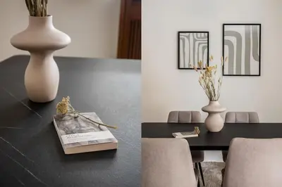 a table with a white vase and a table with chairs at Faliro Sunlit 3BR Apartment by UPSTREET in Athens