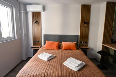 a bedroom with a bed with two orange pillows at Athinas Relax G1 in Athens