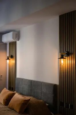 a bedroom with a bed with two lights on it at Athinas Relax G1 in Athens