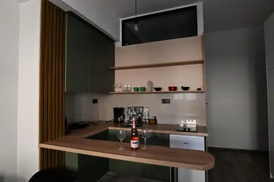 a kitchen with a counter with a bottle of wine on it at Athinas Relax G1 in Athens
