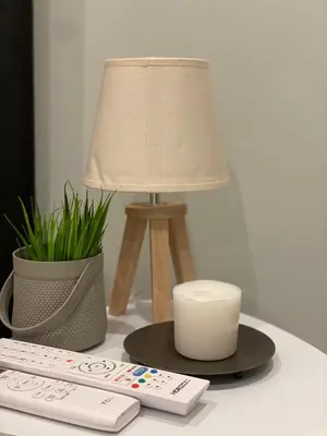 a lamp sitting on a desk next to a remote control at Aiolos apartment alimos centre 4 near the sea in Athens