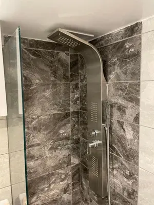 a shower with a glass door in a bathroom at Aiolos apartment alimos centre 4 near the sea in Athens