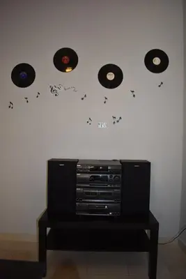 a wall with four records on a wall at Cozy Project Kaisariani in Athens