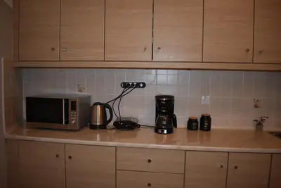 a kitchen counter with a microwave and a coffee maker at Cozy Project Kaisariani in Athens