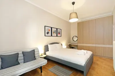 a bedroom with a bed and a couch at Jade Residence - Greecing in Athens