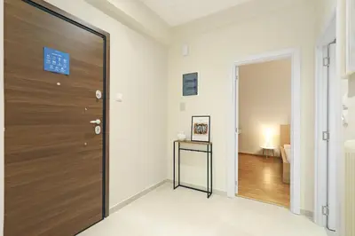 a large wooden door in a room with a hallway at Jade Residence - Greecing in Athens