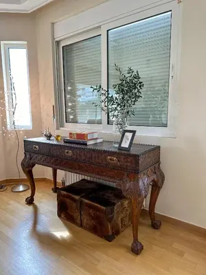 a wooden table in a room with a window at Villa in Voula 5 mins from the Beach in Athens