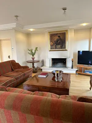 a living room with a couch and a fireplace at Villa in Voula 5 mins from the Beach in Athens