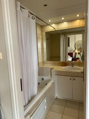 a bathroom with a white shower curtain and a sink at Villa in Voula 5 mins from the Beach in Athens
