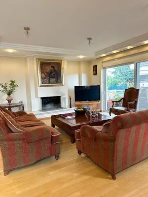 a living room with two couches and a coffee table at Villa in Voula 5 mins from the Beach in Athens