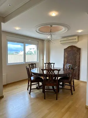 a dining room with a table and chairs at Villa in Voula 5 mins from the Beach in Athens