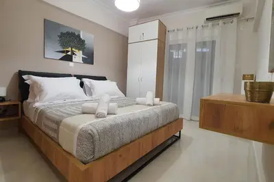 a bedroom with a large bed with two towels on it at Α&J Sweet Home in Athens