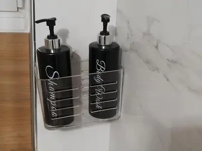 two black bottles are sitting on a wall at Α&J Sweet Home in Athens