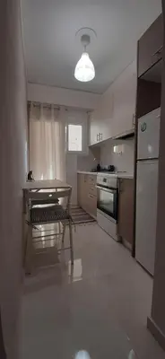 a kitchen with a table and a stove top oven at Α&J Sweet Home in Athens