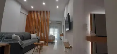 a living room with a couch and a table at Α&J Sweet Home in Athens