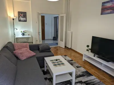 a living room with a couch and a tv at Lavender-Emma cosy apartment near city center in Athens