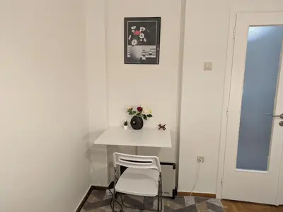 a small white table in a room with a chair at Lavender-Emma cosy apartment near city center in Athens