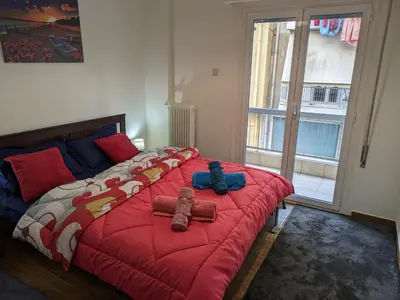 a bedroom with a bed with two stuffed animals on it at Lavender-Emma cosy apartment near city center in Athens