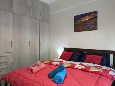 a bedroom with a bed with two stuffed animals on it at Lavender-Emma cosy apartment near city center in Athens