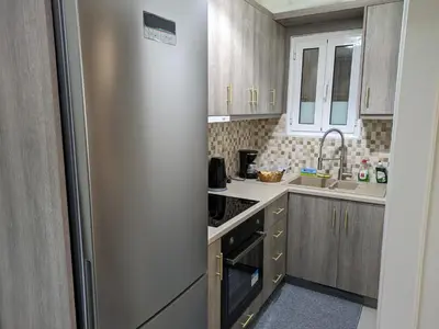a kitchen with a stainless steel refrigerator at Lavender-Emma cosy apartment near city center in Athens