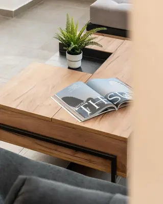 a wooden coffee table with a book on it at Ranny House in Athens