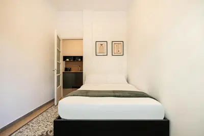 a bedroom with a bed in a white wall at Ranny House in Athens