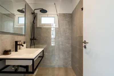a bathroom with a sink and a mirror at Ranny House in Athens
