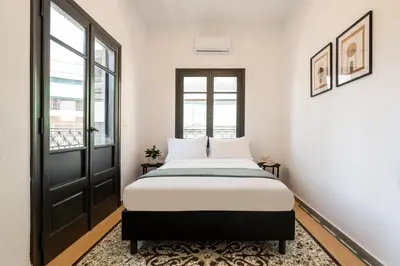 a bedroom with a bed and a window at Ranny House in Athens