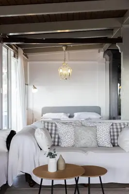 a bedroom with a large white bed with a chandelier at Sunny Loft with a Panoramic View in Athens
