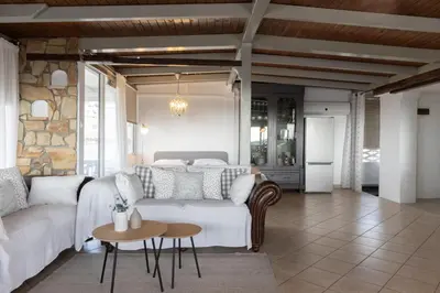 a living room with a white couch and a table at Sunny Loft with a Panoramic View in Athens