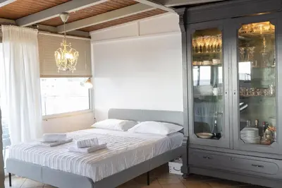 a bedroom with a bed and a chandelier at Sunny Loft with a Panoramic View in Athens