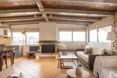 a living room with a couch and a fireplace at Sunny Loft with a Panoramic View in Athens