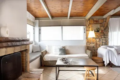 a living room with a couch and a fireplace at Sunny Loft with a Panoramic View in Athens