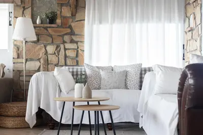 a living room with a couch and a table at Sunny Loft with a Panoramic View in Athens