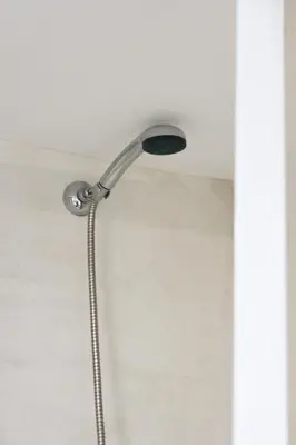 a shower with a shower head in a bathroom at Sunny Loft with a Panoramic View in Athens