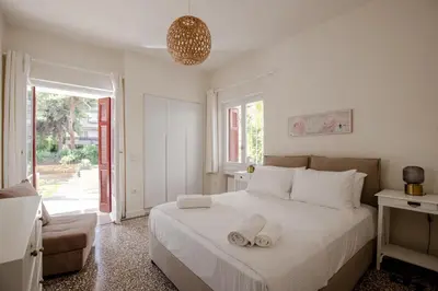 a bedroom with a bed with two towels on it at Private house - Garden - Glyfada in Athens