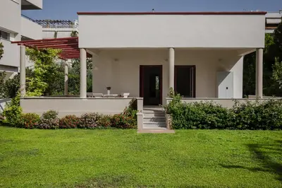 a white house with a lawn in front of it at Private house - Garden - Glyfada in Athens