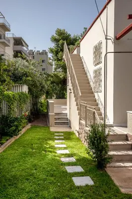 a stairway leading up to a building with grass at Private house - Garden - Glyfada in Athens