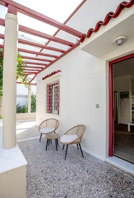 a patio with two chairs and a table at Private house - Garden - Glyfada in Athens